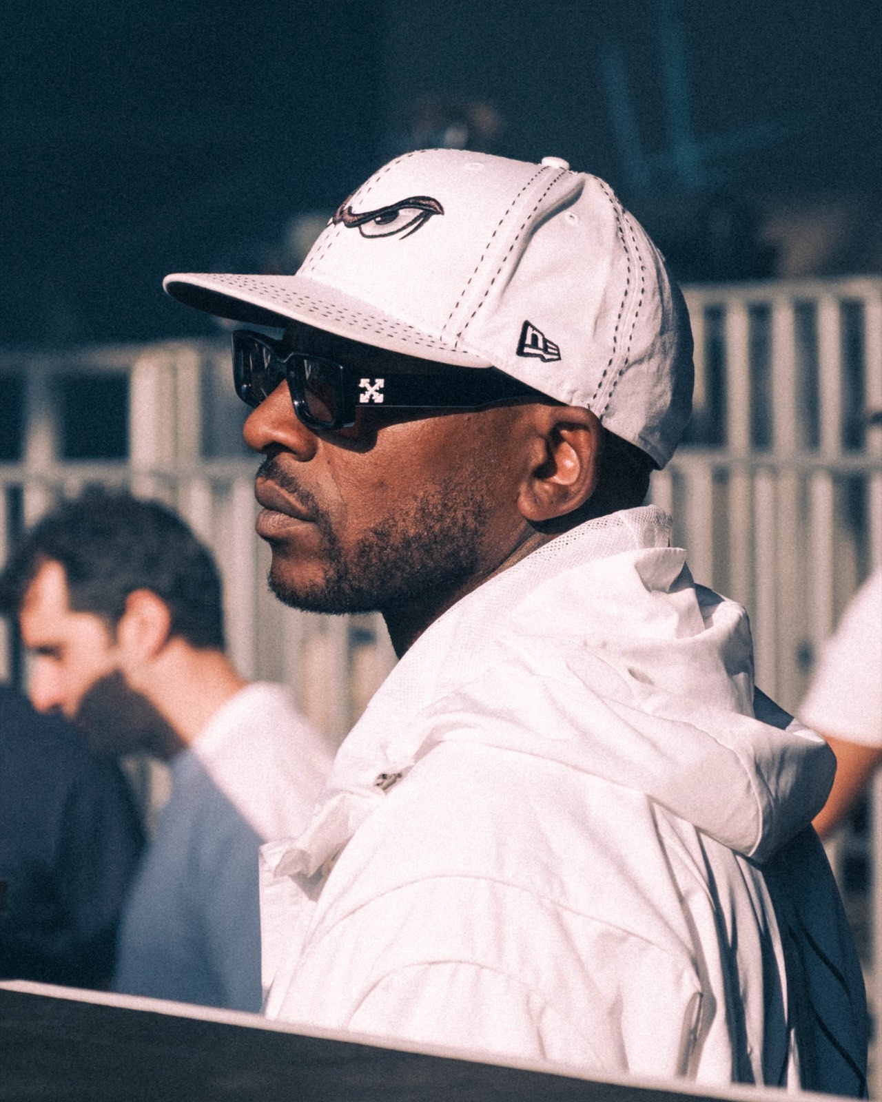 Portrait at Big Smoke wearing a white cap and sunglasses.