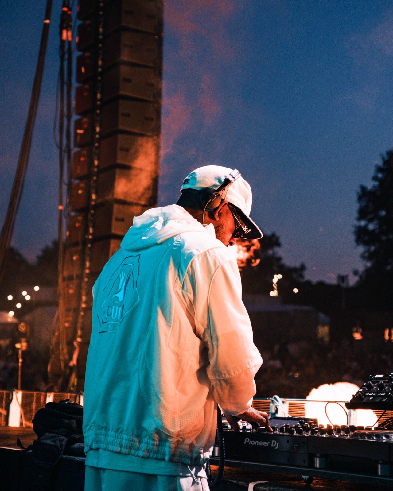 DJ working at the decks as the light changes at Big Smoke.