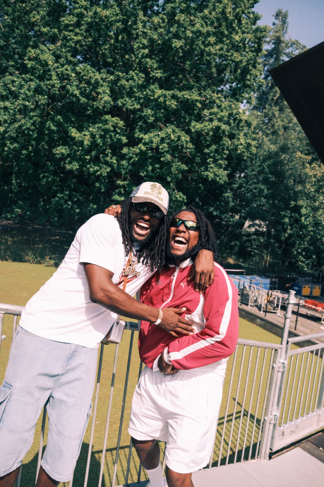 Two friends laughing together beside the stage.