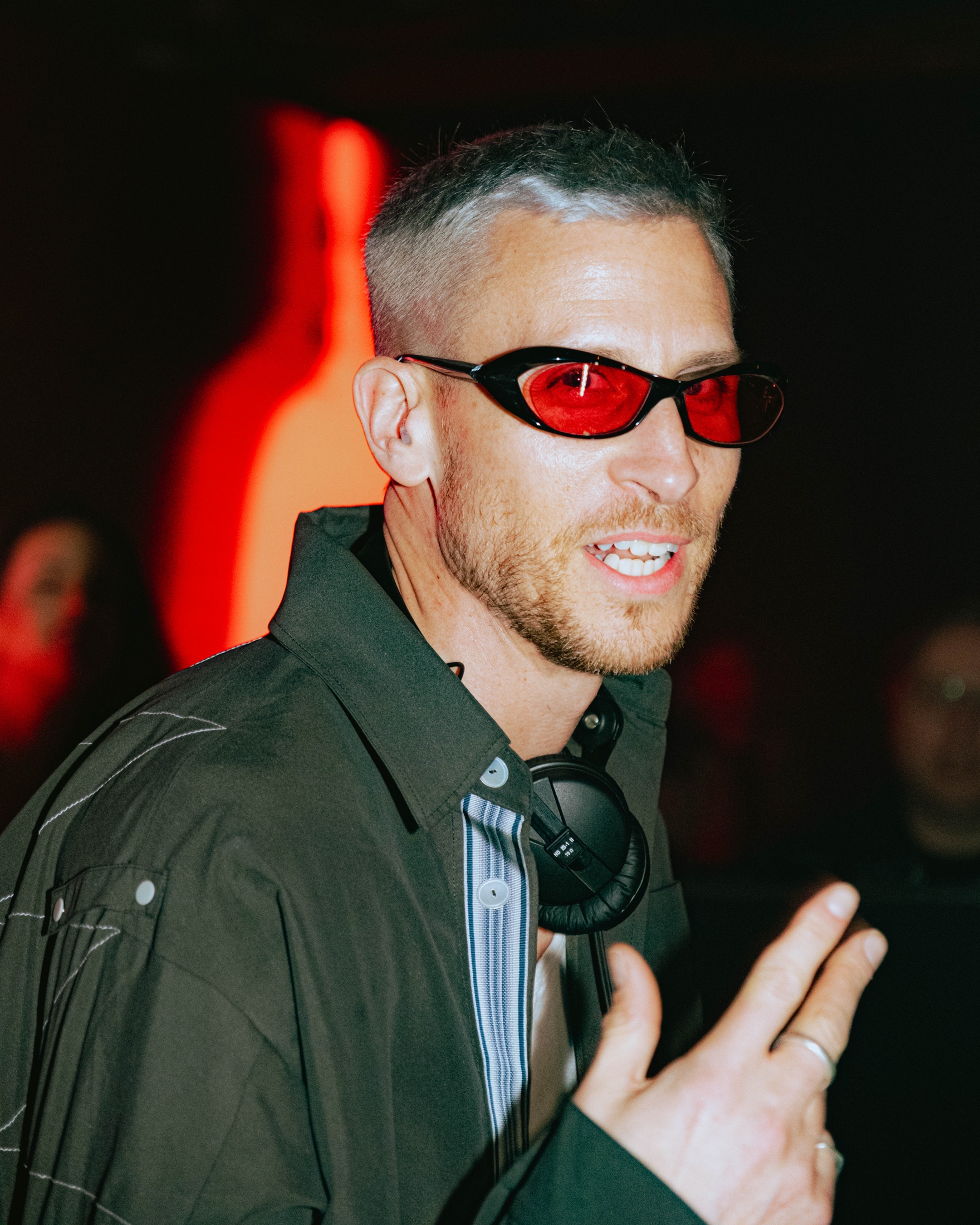 Close portrait of Eli Brown wearing red glasses before a set.