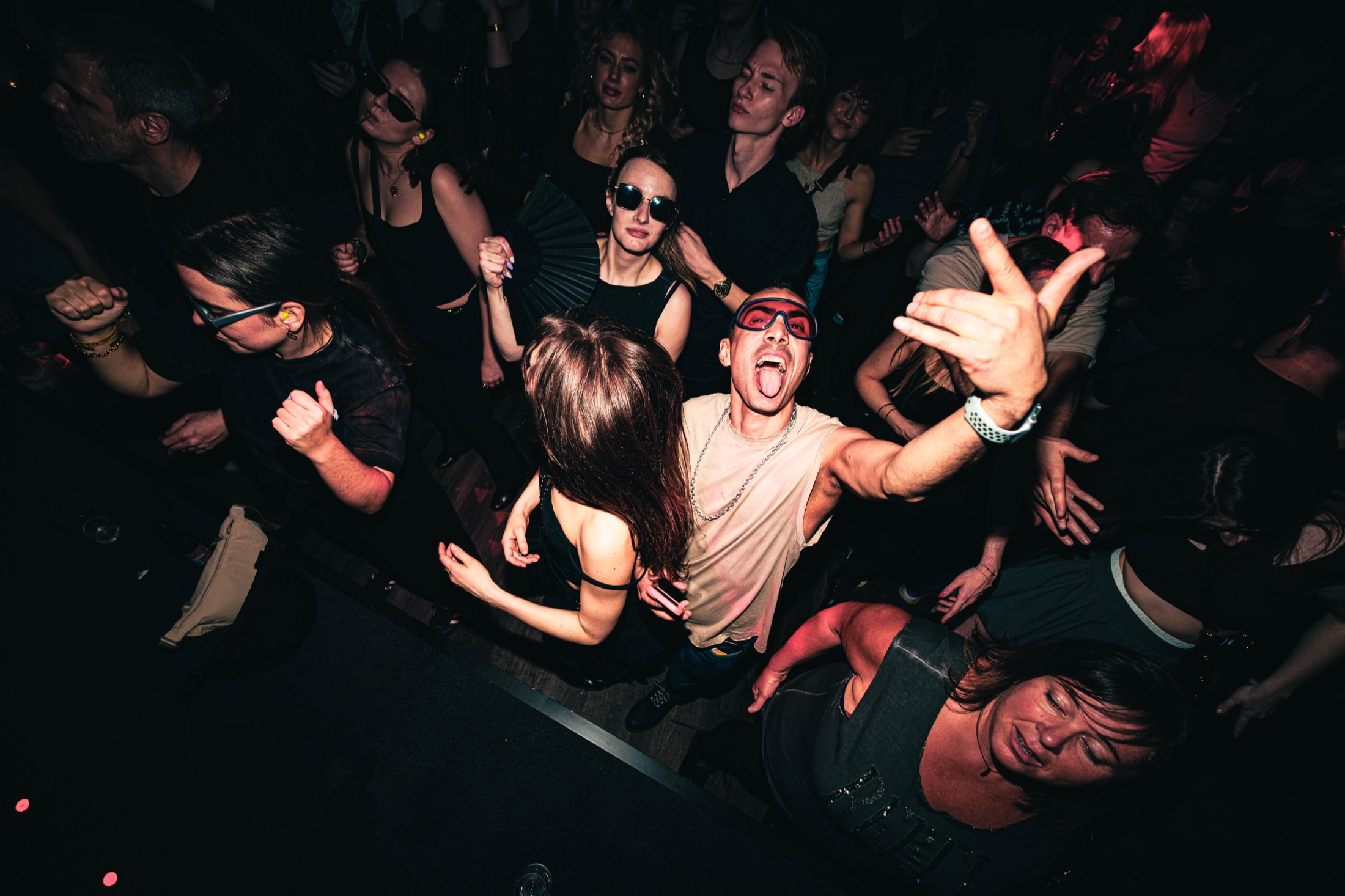 A club crowd dancing under direct flash.