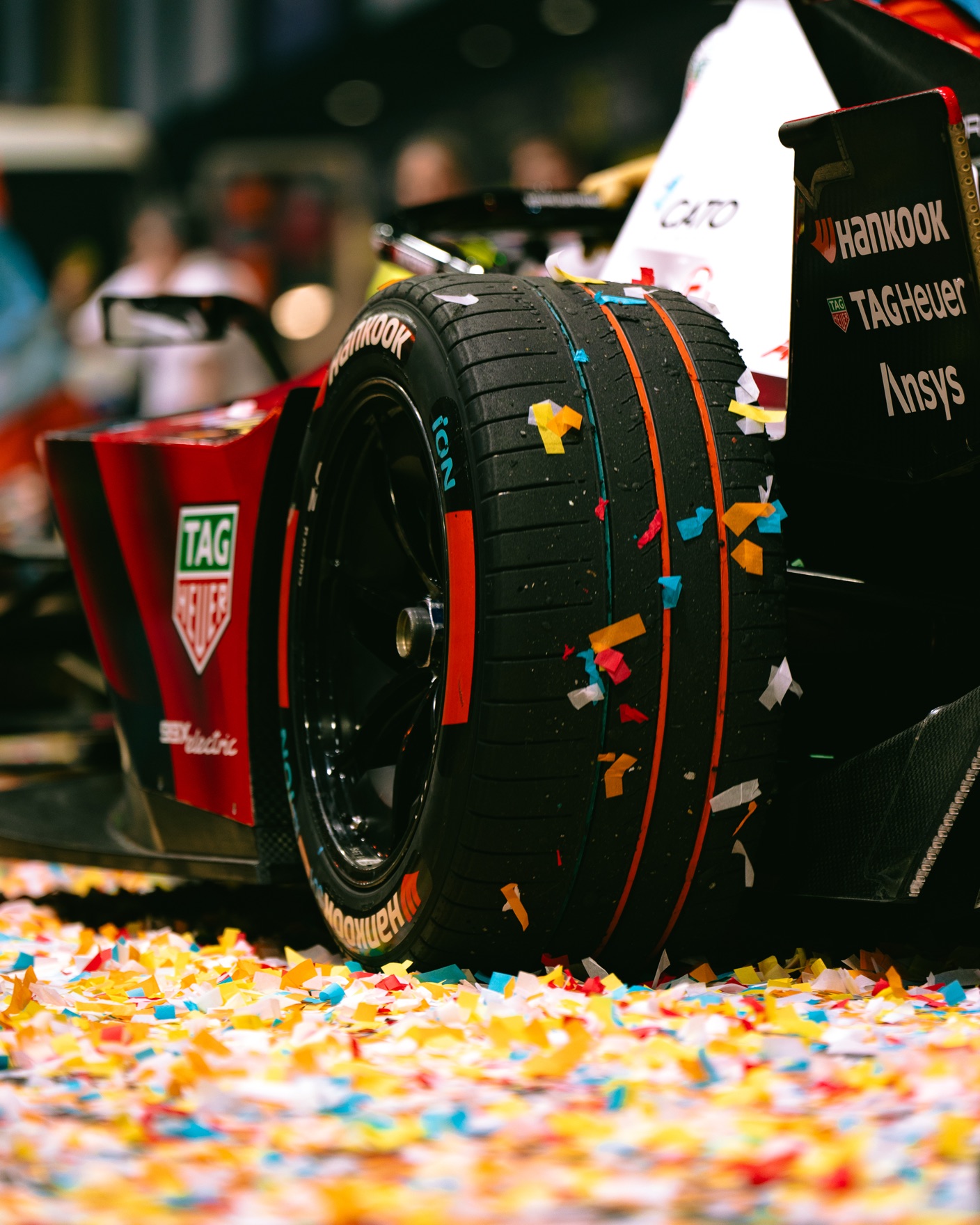Formula E racing car wheel covered in confetti