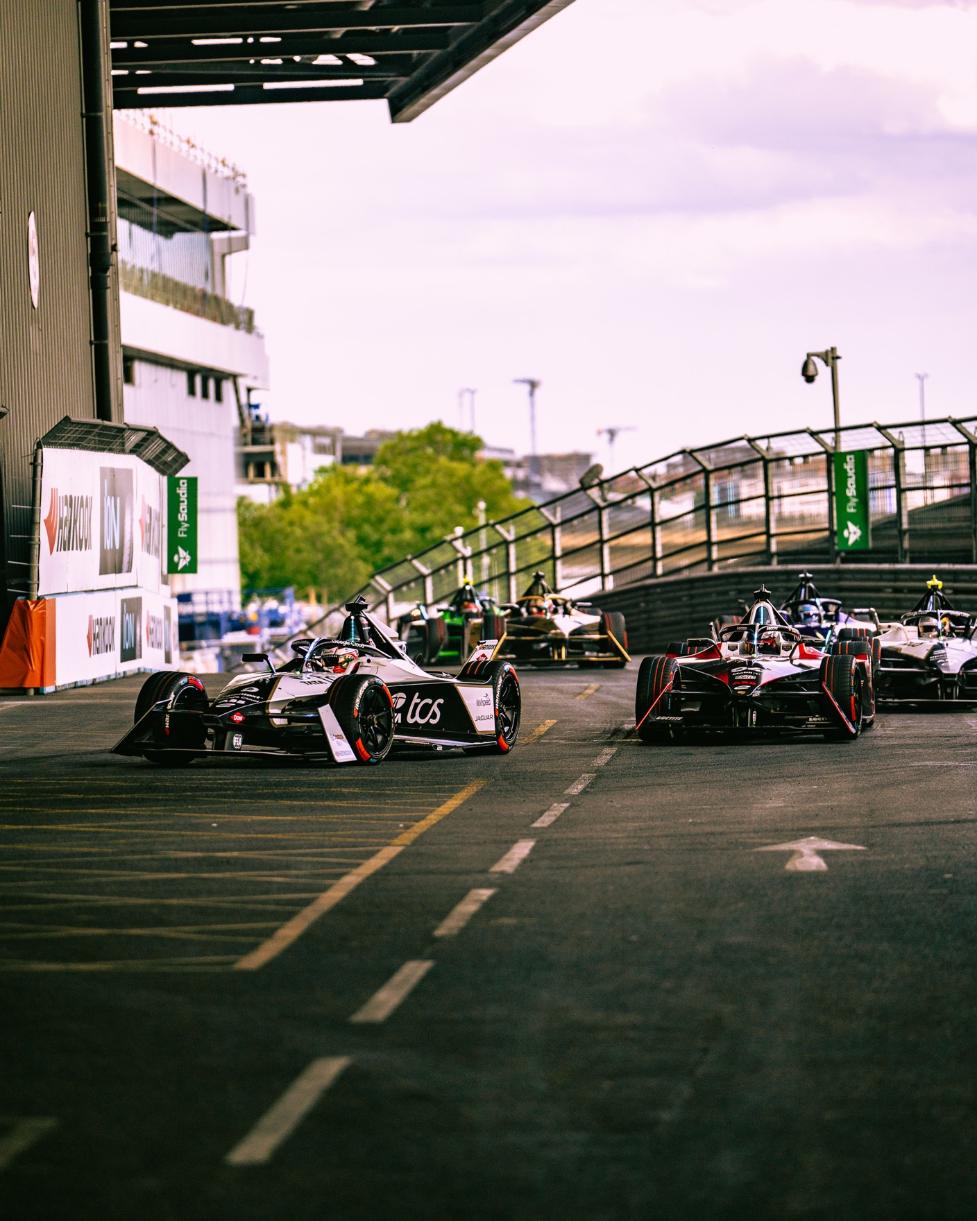 A pack of Formula E cars racing at ExCeL London