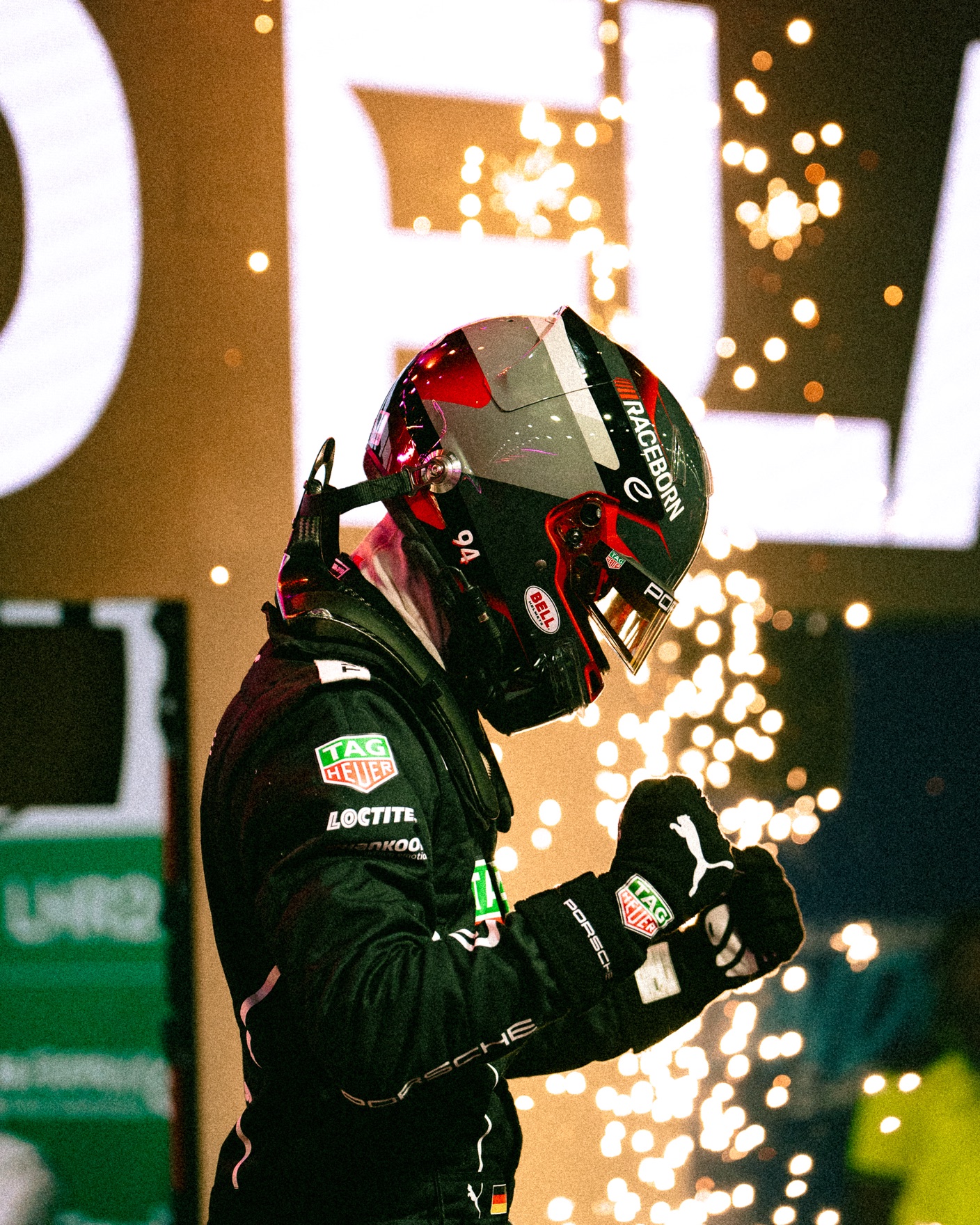 Porsche Formula E driver celebrating with sparks behind him