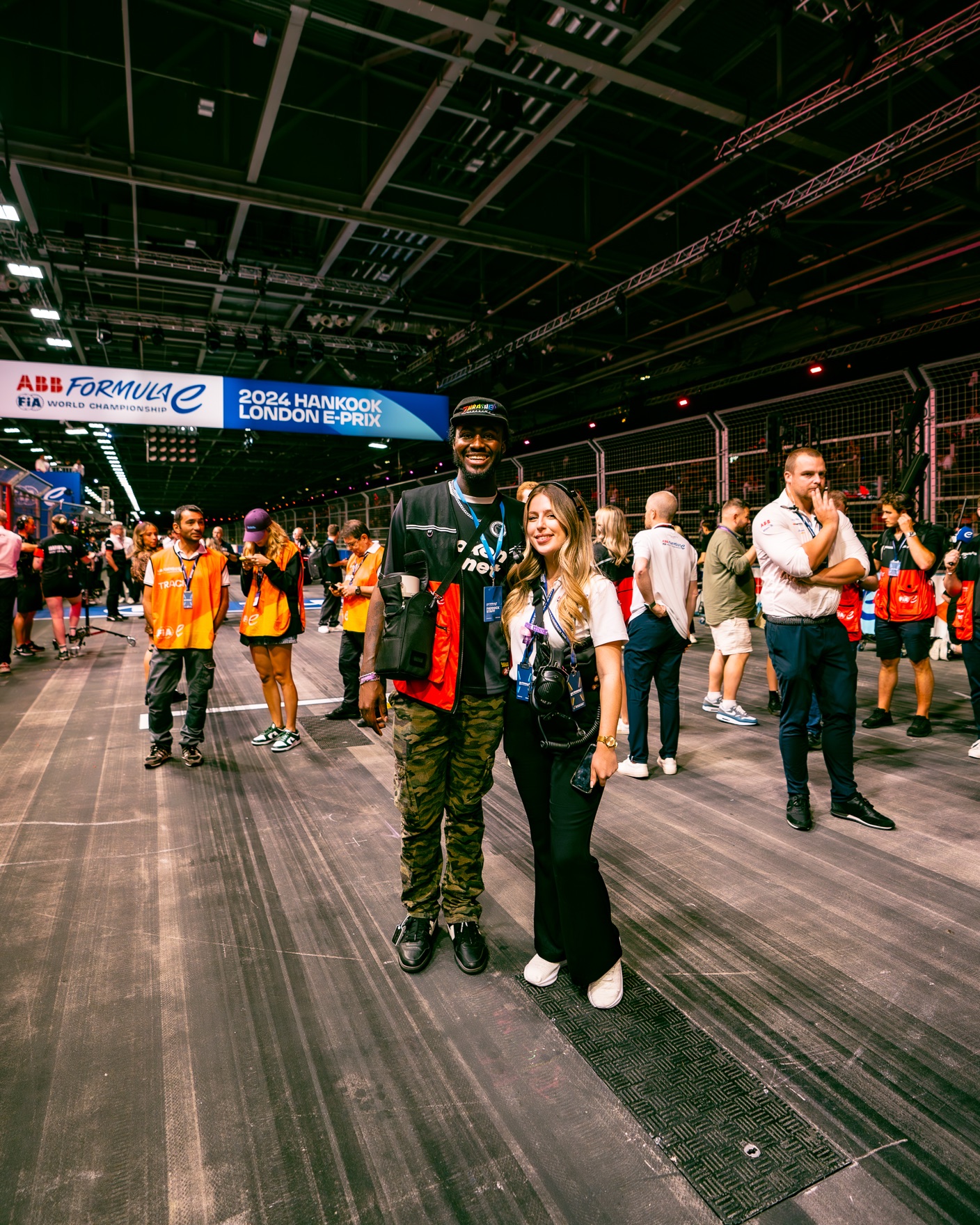 Demonét and an event photographer on the Formula E track floor