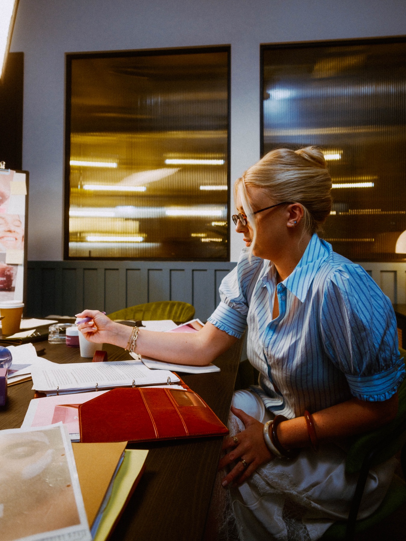 A boardroom scene with scripts and OLEHENRIKSEN product references