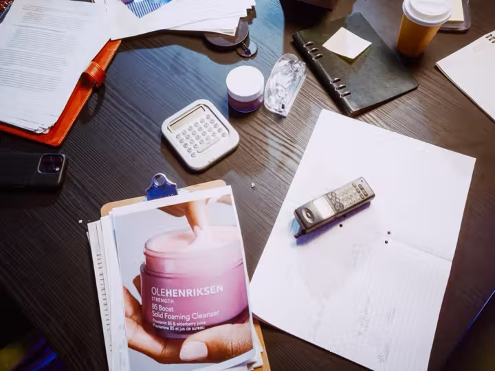 OLEHENRIKSEN cleanser reference and stationery on the campaign’s boardroom table
