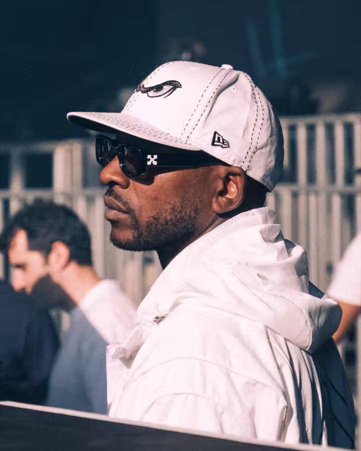 Portrait at Big Smoke wearing a white cap and sunglasses