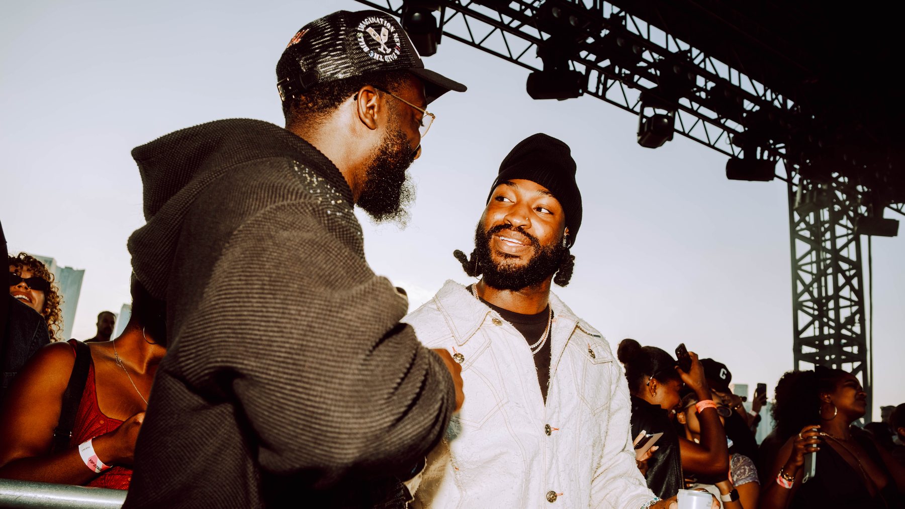 Two guests greeting each other beside the R&B Slow Jams stage.