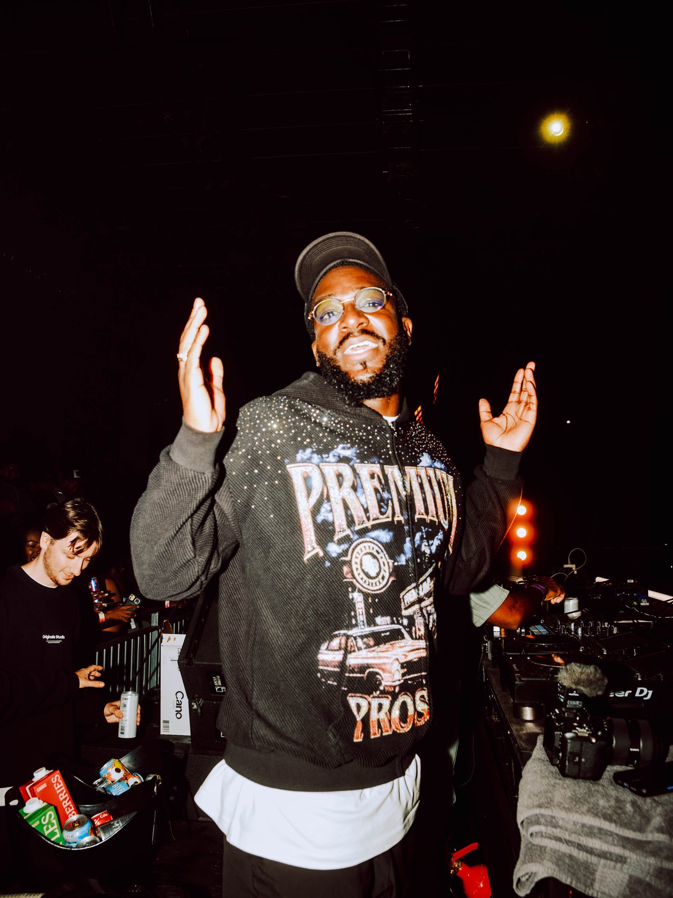 Odeal smiling beside the stage during R&B Slow Jams at Magazine London.