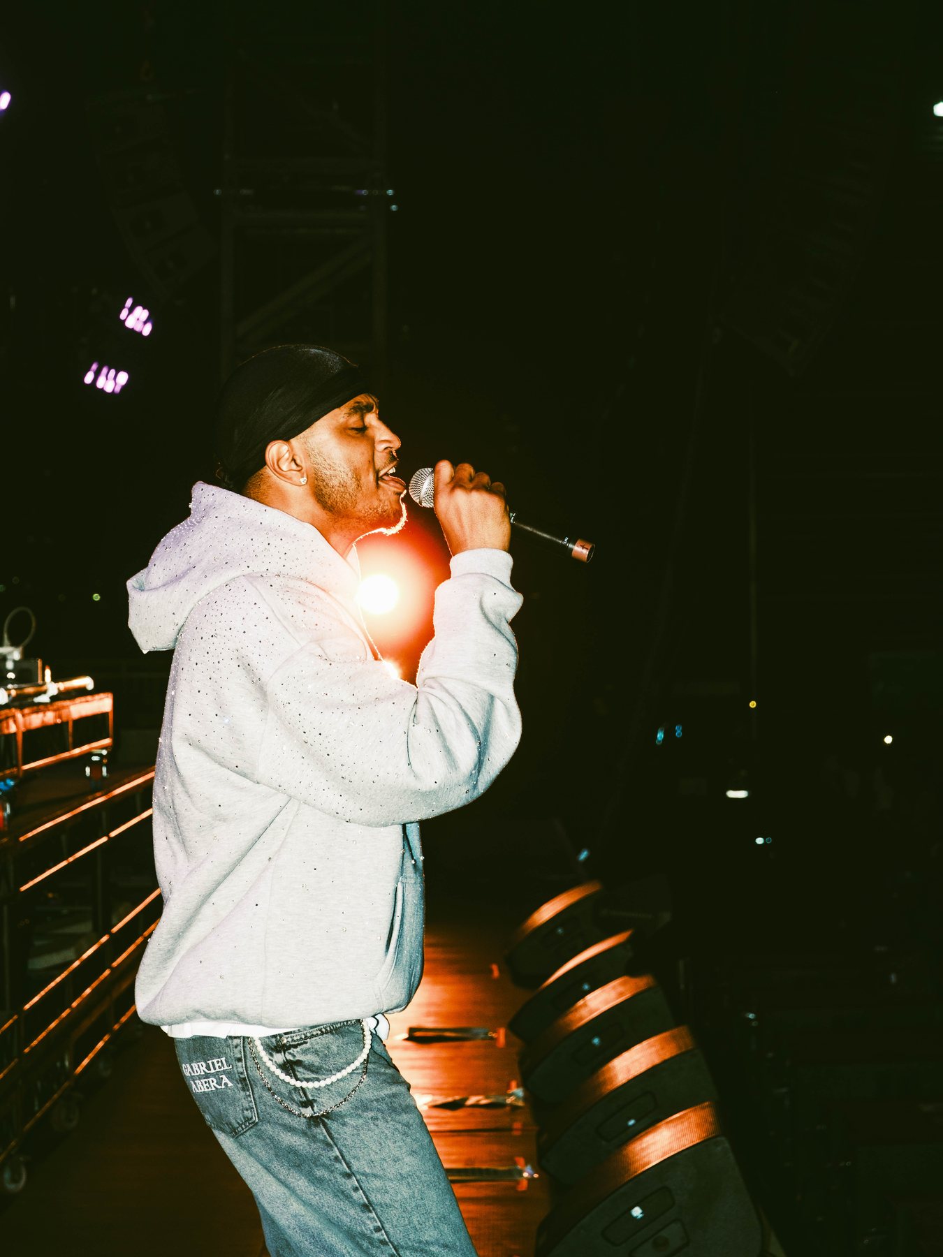 Performer singing under warm stage lighting at R&B Slow Jams