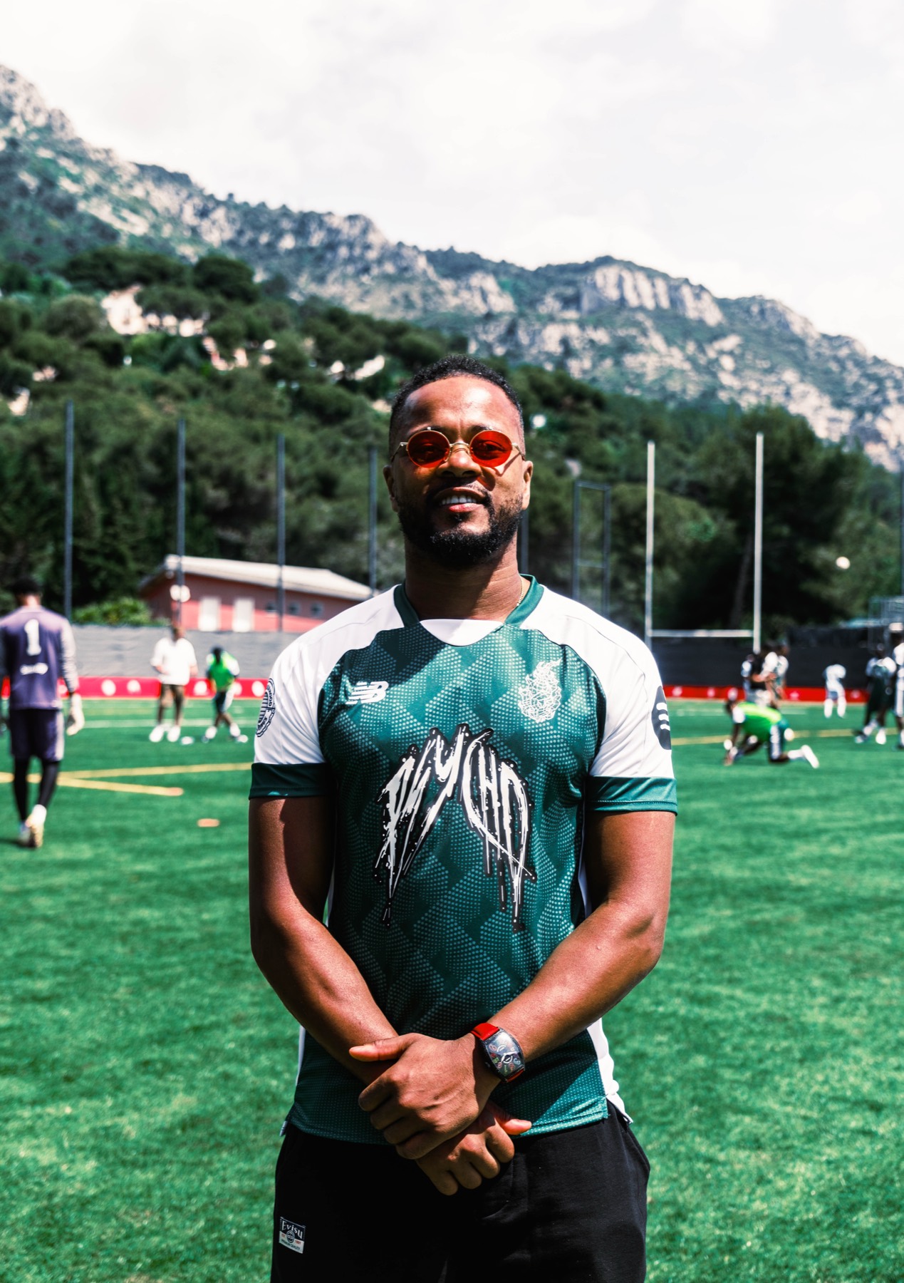 Player wearing red sunglasses photographed on the Santan Cup pitch.