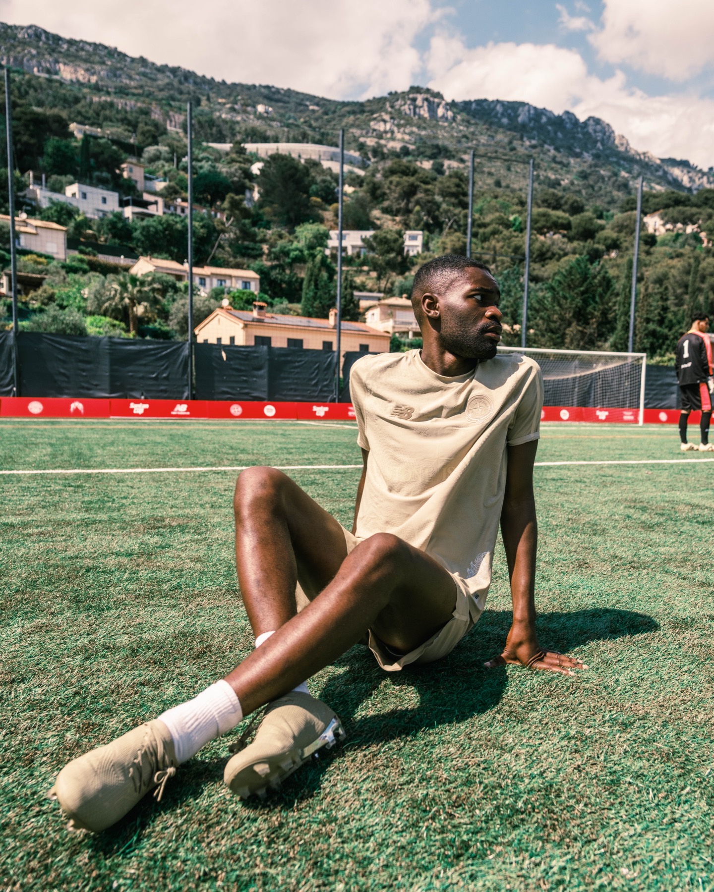 Player resting on the pitch between Santan Cup moments.