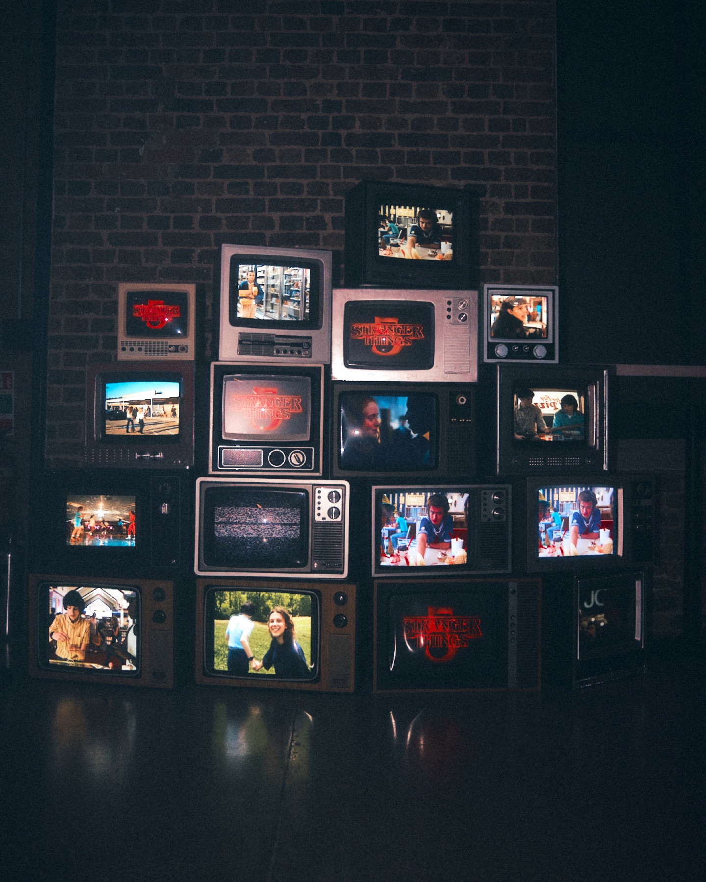 Wall of vintage television screens playing Stranger Things scenes