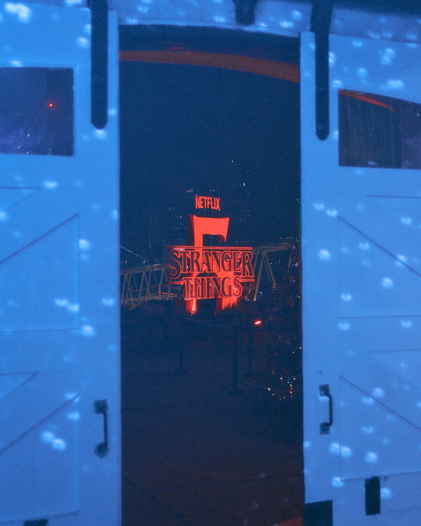 Netflix Stranger Things 5 title seen through doors lit blue