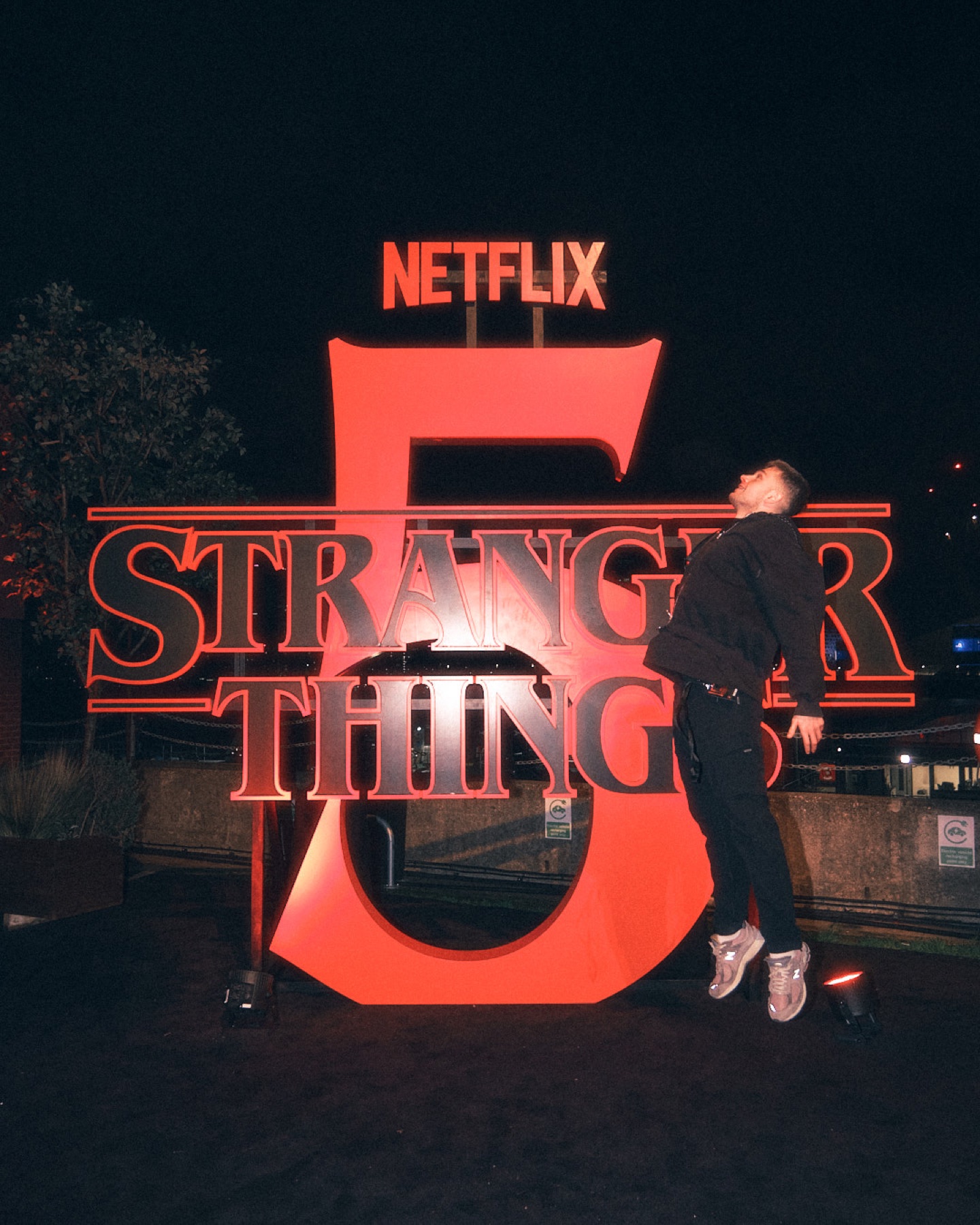 Guest posing beneath the Netflix Stranger Things 5 title