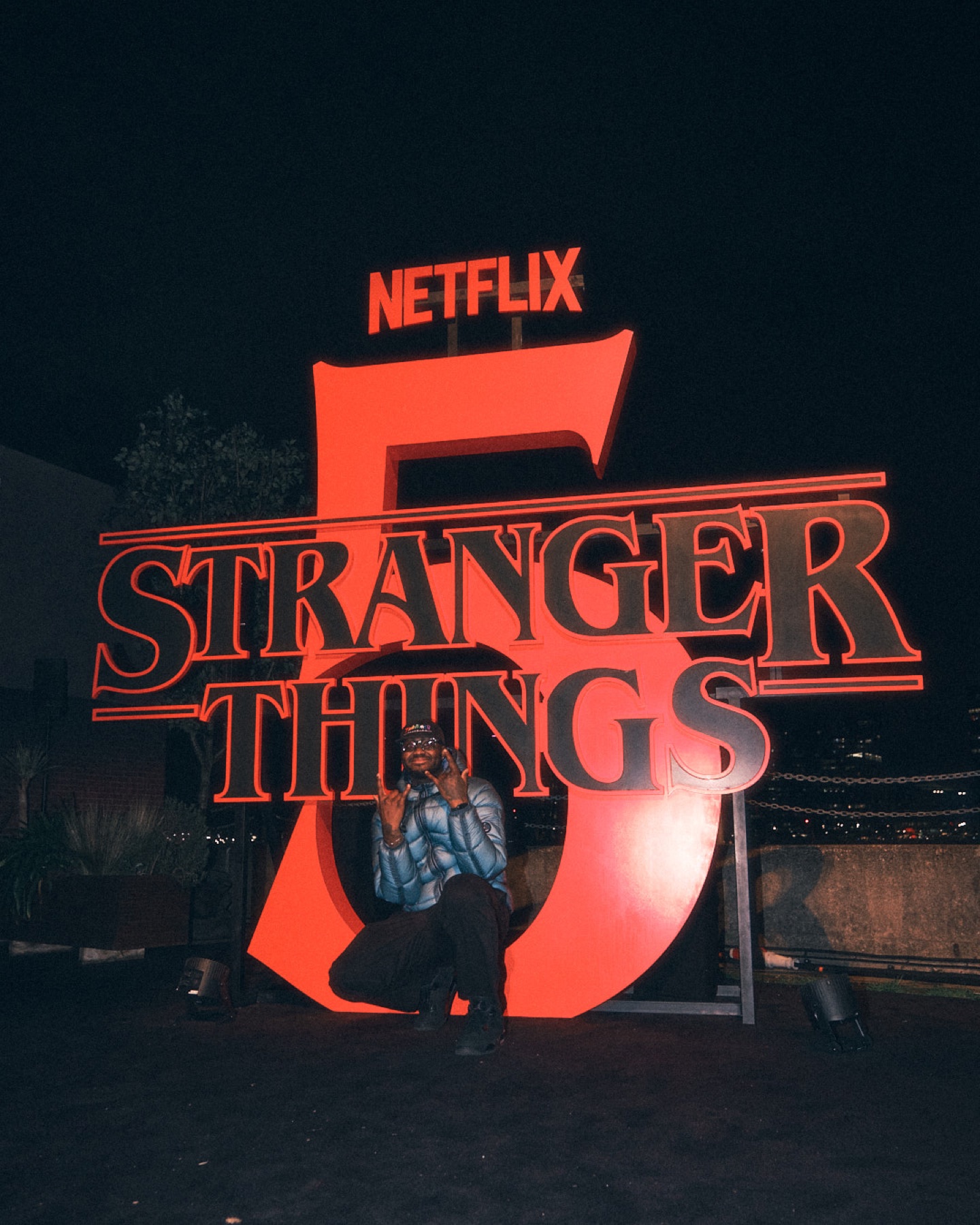 Two guests posing in front of the Stranger Things 5 installation