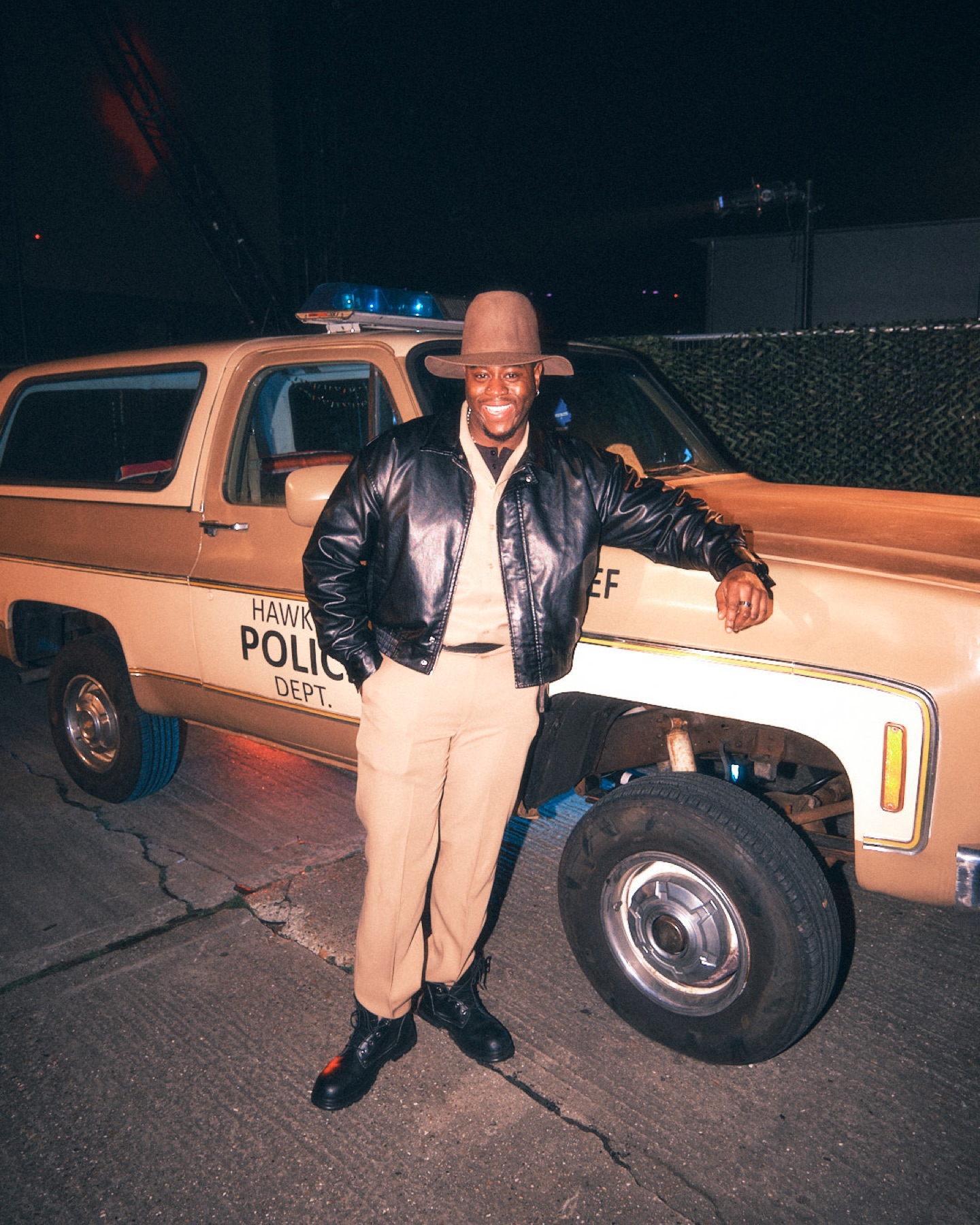 Guest standing beside a Hawkins police vehicle