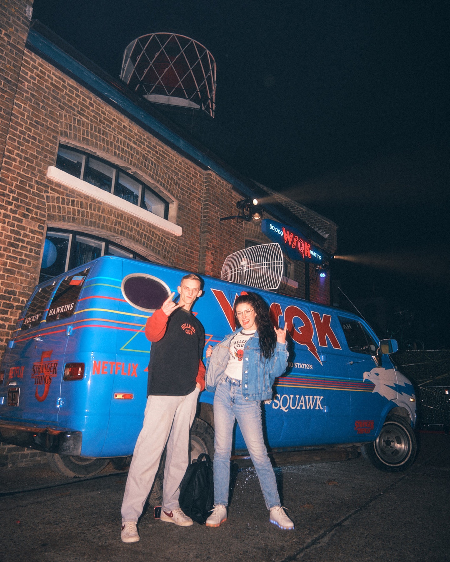 Guests gathered beside a Stranger Things themed WSQK radio van