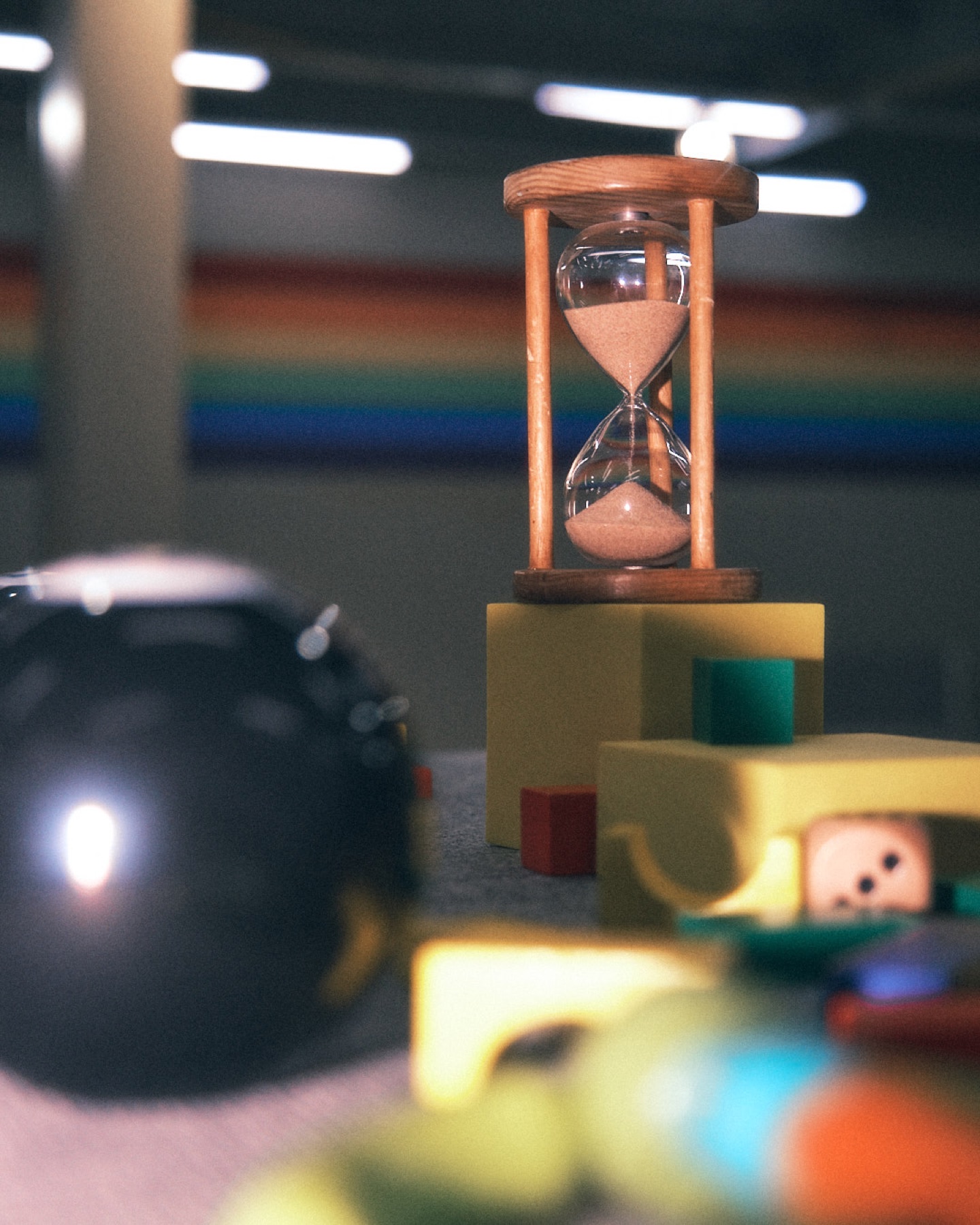 Hourglass prop arranged among colourful objects