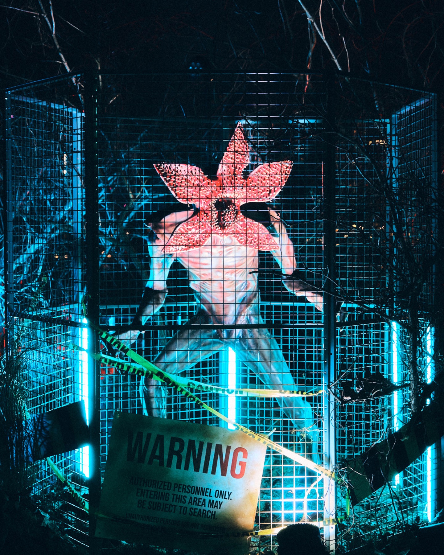 Demogorgon installation surrounded by warning tape and blue light